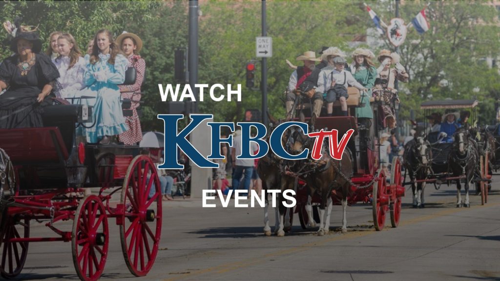 Two horse-drawn buggies with women in pioneer dresses at Cheyenne Frontier Days parade.